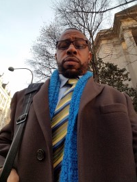 Sadiqq standing outside of an office in DC